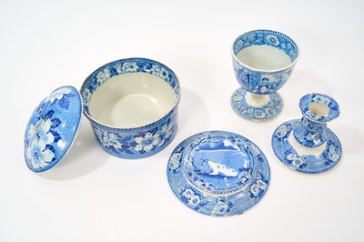 Lot 79 - Early 19th century blue and white part smoker's set, comprising goblet, candlestick and stand, the goblet in the Cow Polisher pattern, together with butter dish and cover with pierced hearts to...
