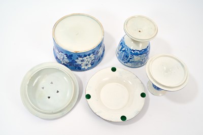 Lot 79 - Early 19th century blue and white part smoker's set, comprising goblet, candlestick and stand, the goblet in the Cow Polisher pattern, together with butter dish and cover with pierced hearts to...