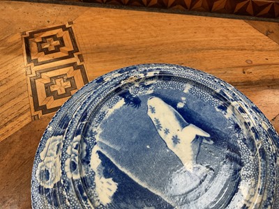 Lot 79 - Early 19th century blue and white part smoker's set, comprising goblet, candlestick and stand, the goblet in the Cow Polisher pattern, together with butter dish and cover with pierced hearts to...