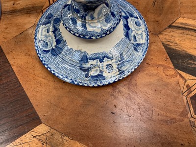 Lot 79 - Early 19th century blue and white part smoker's set, comprising goblet, candlestick and stand, the goblet in the Cow Polisher pattern, together with butter dish and cover with pierced hearts to...