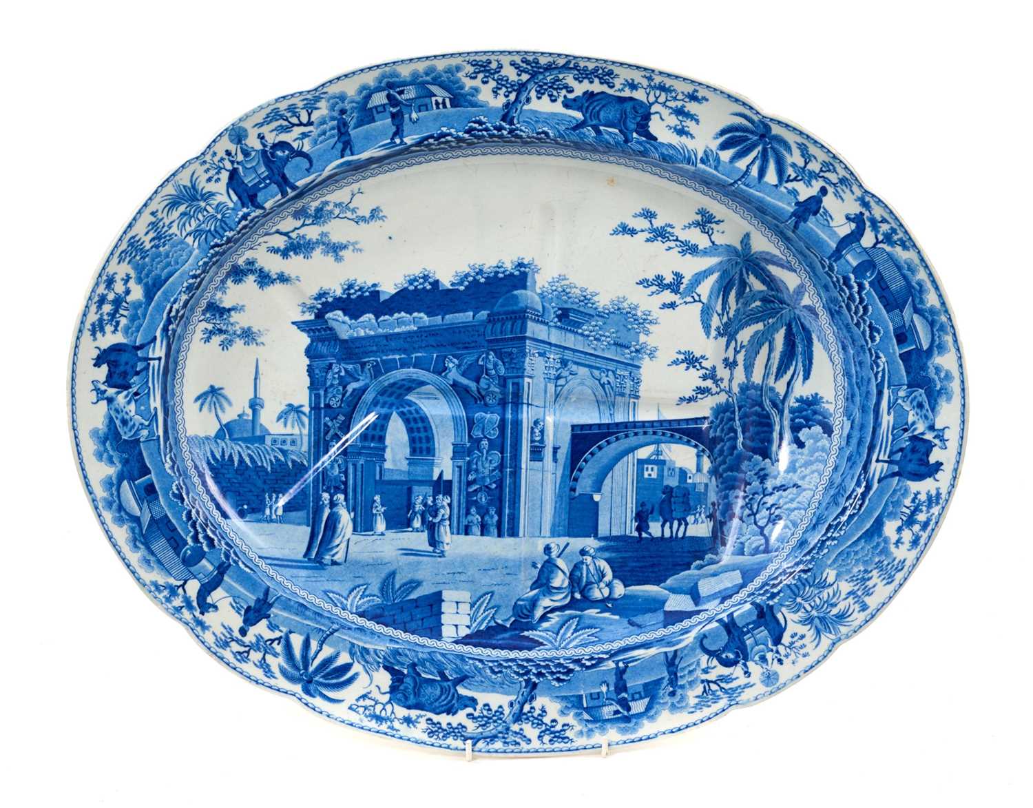 Lot 85 - Early 19th century Spode blue and white oval 'well and tree' platter, printed with the Caramanian Triumphal Arch of Tripoli in Barbary, impressed 'Spode' mark, 52.5cm wide