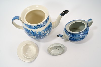 Lot 88 - Large early 19th century blue and white punch pot and cover, printed with chinoiserie scene, 32.5cm from spout to handle, together with a blue and white teapot with rural scene, 23cm (2)