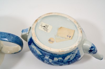 Lot 88 - Large early 19th century blue and white punch pot and cover, printed with chinoiserie scene, 32.5cm from spout to handle, together with a blue and white teapot with rural scene, 23cm (2)