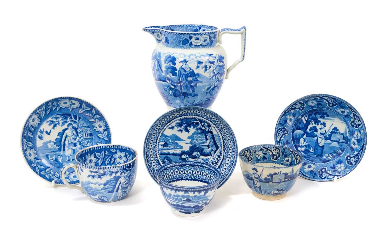 Lot 92 - Group of early 19th century blue and white printed items including two tea bowls with saucers and one cup with saucer, patterns including Feeding Chickens and Gun Dogs, together with a jug print...