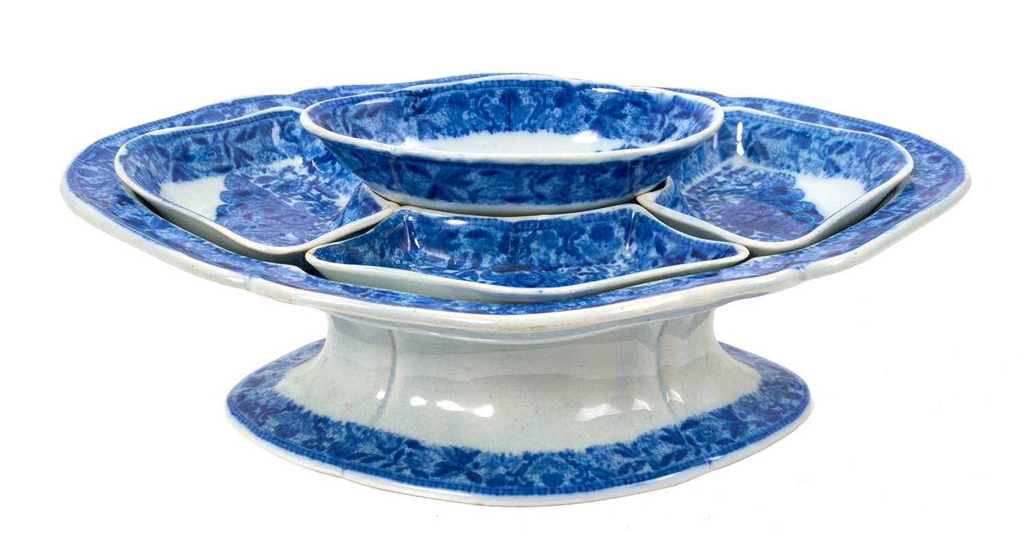 Lot 93 - Early 19th century blue and white pickle set, of lozenge form on pedestal base, with five small fitted dishes, printed with the Flower Cross pattern, 28cm across