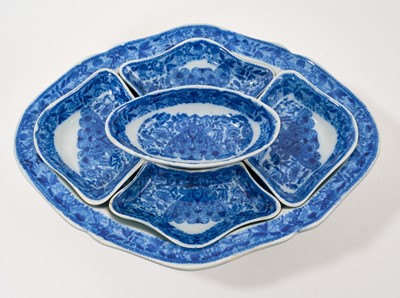 Lot 93 - Early 19th century blue and white pickle set, of lozenge form on pedestal base, with five small fitted dishes, printed with the Flower Cross pattern, 28cm across
