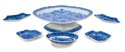 Lot 93 - Early 19th century blue and white pickle set, of lozenge form on pedestal base, with five small fitted dishes, printed with the Flower Cross pattern, 28cm across