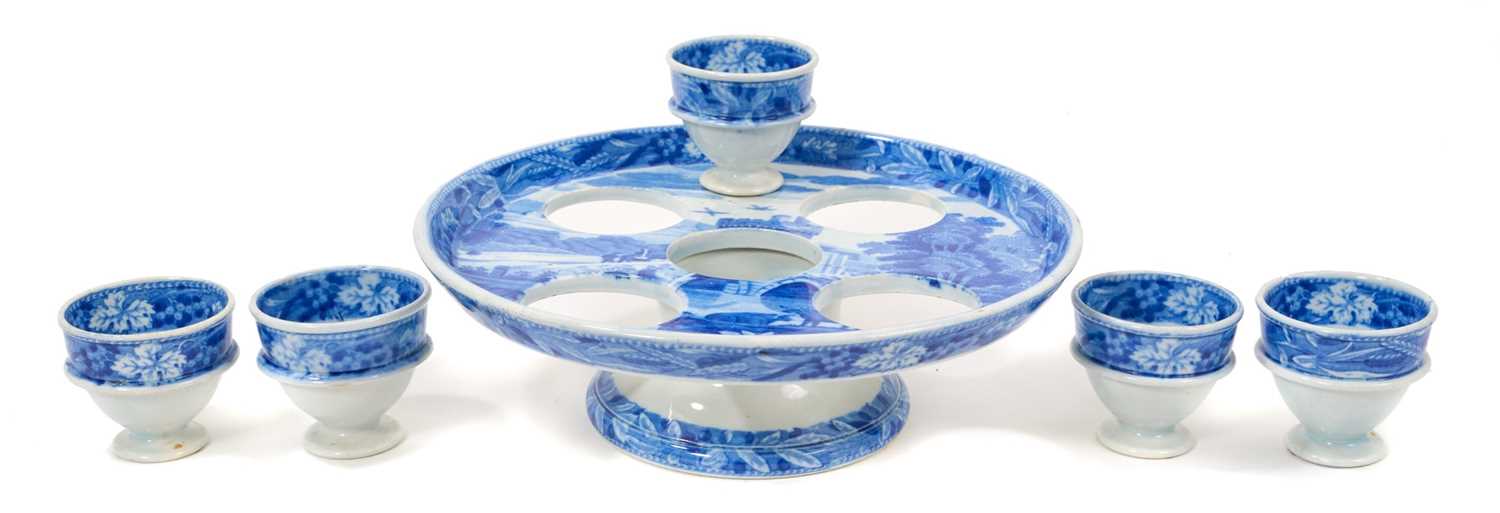 Lot 96 - Early 19th century Spode blue and white egg cruet, printed in the Bridge of Lucarno pattern, printed 'Spode' mark to all pieces, the stand 19cm diameter