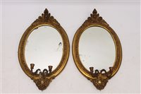 Lot 1274 - Pair of 19th century oval gilt gesso girandole...