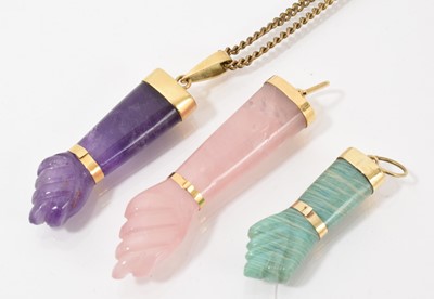 Lot 485 - Carved amethyst Mano Figa pendant with yellow metal mounts, stamped '18k', on plated chain, together with two other similar (3)