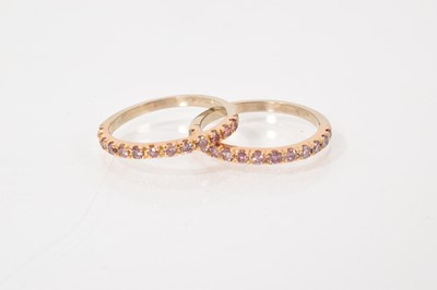 Lot 486 - Pair of pink diamond eternity rings, each with a half hoop of pink diamonds (heat treated)