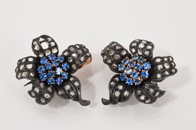 Lot 532 - Pair of diamond and blue gem set flower brooches