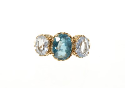 Lot 437 - Sapphire three stone ring with a central oval mixed cut blue sapphire measuring approximately 9.7mm x 7mm flanked by two pale blue oval mixed cut sapphires measuring 7.5 x 6mm and 7.5mm x 5.7mm...