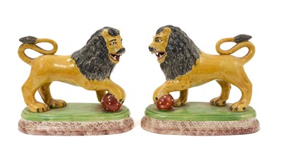 Lot 134 - Pair of early 19th century Staffordshire models of lions, with sponge bases.