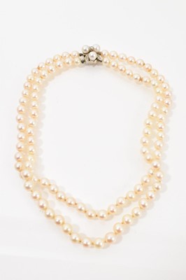 Lot 479 - Cultured pearl double-strand necklace with 14ct white gold and diamond clasp