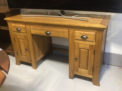 Lot 5335 - Oak desk with three drawers and two small cupboards measuring approximately 136cm wide