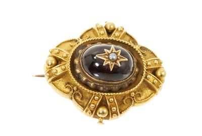 Lot 477 - Victorian Etruscan revival gold and cabochon garnet brooch