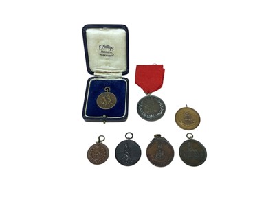 Lot 41 - Collection of seven various bronze military fobs to include a 1917 wheelbarrow race fob, (7)
