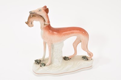 Lot 163 - Mid-19th century Staffordshire pottery greyhound
