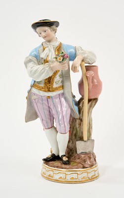 Lot 148 - Meissen figure of a gardener, shown standing next to a tree trunk with a watering can and spade, underglaze blue crossed swords mark and incised 'C 69' to base