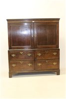 Lot 1340 - George III oak press cupboard with dentil...