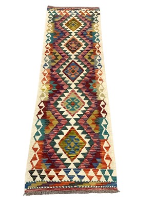 Lot 5369 - Kilim runner with five central medallions on cream and multicoloured ground, 200cm x 57cm
