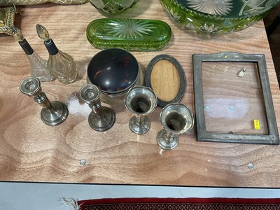 Lot 5171 - Group of silver, including two photo frames, a large tortoiseshell lidded pot, pair of spill vases, two cut glass bottles with silver collars, and a pair of candlesticks