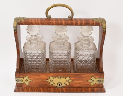 Lot 870 - Victorian three decanter tantalus, with key