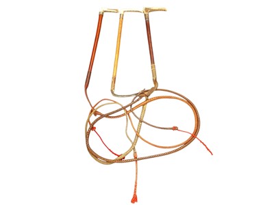 Lot 945 - Three hunting whips including Champion & Wilson silver mounted, another early 20th century silver mounted, the third with white metal mount, each with horn handle (3)