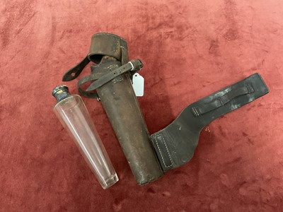 Lot 908 - Leather cased glass saddle flask with silver plated top, for saddle mounting