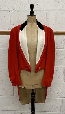 Lot 922 - Vintage red hunt tail coat with black velvet collar and white lapels, with brass buttons