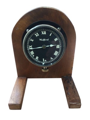 Lot 101 - 1920s 'Watford' car clock in nickel and black painted case by North & Sons Ltd, mounted on wooden plinth, clock case 8.5cm in diameter.