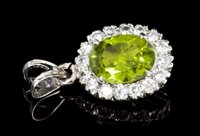 Lot 531 - Peridot and diamond cluster pendant with a...