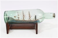 Lot 818 - Early 20th century ship in a bottle with three...