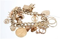 Lot 539 - Gold (9ct) charm bracelet with numerous gold...