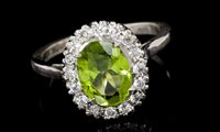 Lot 529 - Peridot and diamond cluster ring, centred with...