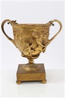 Lot 746 - After the antique, gilt metal twin-handled urn...