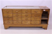 Lot 1411 - Early 20th century light oak shop display...