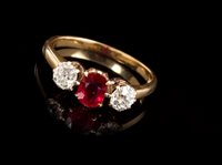 Lot 470 - Ruby and diamond three stone ring with an oval...