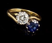 Lot 498 - Diamond and sapphire two stone ring with a...