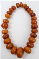 Lot 522 - Old amber bead necklace with a string of...