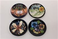 Lot 15 - Four Moorcroft Collectors Club circular pin...