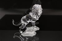 Lot 46 - Swarovski crystal lion standing on a rock, boxed