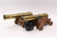 Lot 1597 - Pair of miniature cast brass cannons on wooden...