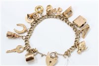 Lot 1268 - Gold (9ct) charm bracelet with various gold...