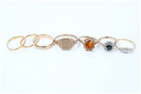 Lot 1269 - Group of seven gold rings - to include two...