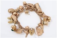 Lot 3207 - Gold (9ct) charm bracelet with twenty-three...