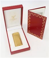 Lot 3528 - Cartier gold plated cigarette lighter with...