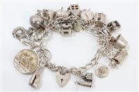 Lot 3292 - Silver charm bracelet with quantity of silver...