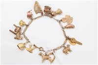 Lot 3294 - Gold (9ct) charm bracelet with various gold...